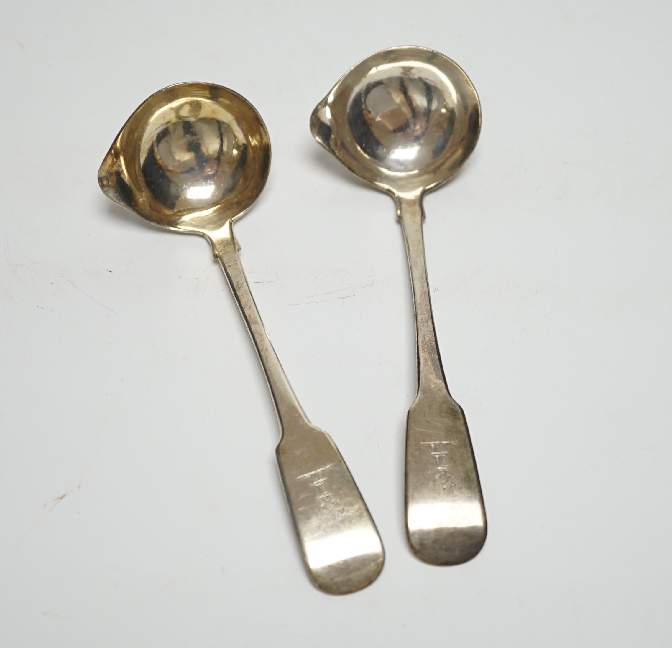 A pair of George IV Irish silver fiddle pattern sauce ladles, Lawrence Nowlan, Dublin, 1825, 15.8cm.